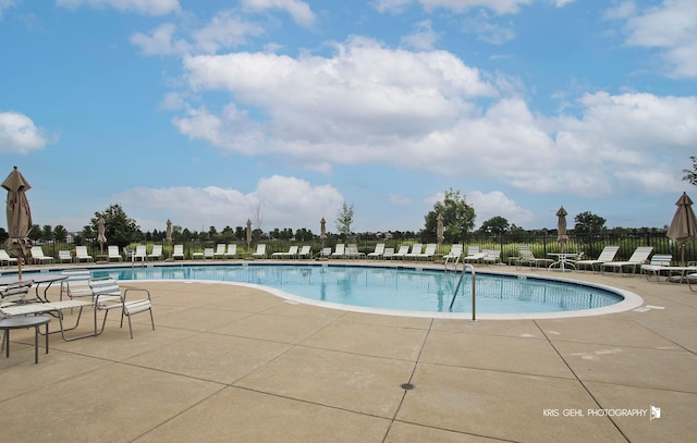 pool featuring a patio area and fence