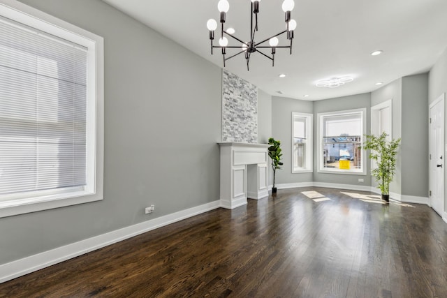 unfurnished living room featuring recessed lighting, a fireplace, dark wood-style flooring, and baseboards