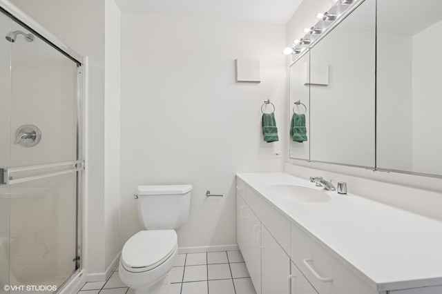 bathroom with baseboards, toilet, a stall shower, tile patterned floors, and vanity