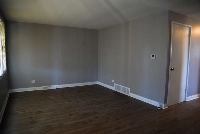 interior space featuring visible vents, baseboards, and dark wood-style flooring