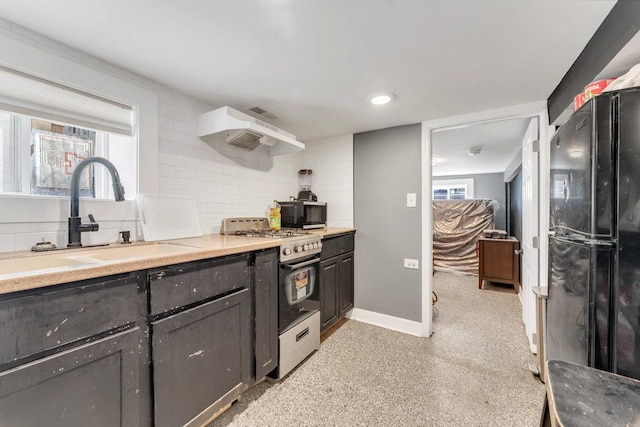216 W 105th St, Chicago, IL 60628 - kitchen featuring extractor fan, baseboards, light countertops, black appliances, and a sink