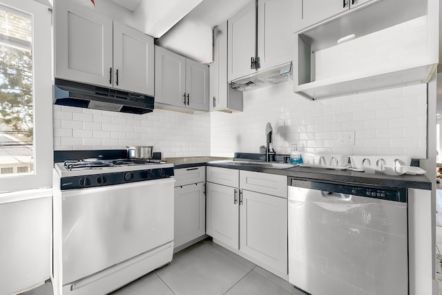 216 W 105th St, Chicago, IL 60628 - kitchen featuring gas range gas stove, a sink, decorative backsplash, under cabinet range hood, and stainless steel dishwasher