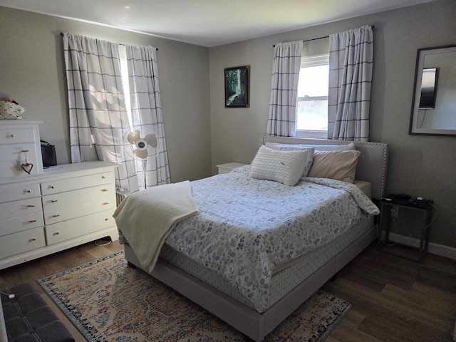 bedroom with baseboards and wood finished floors