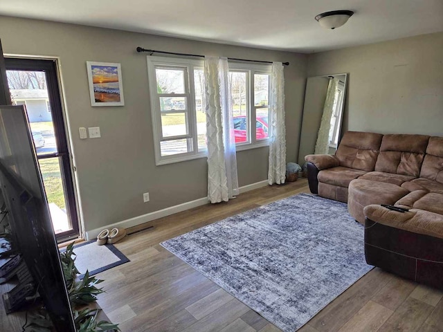 living room with baseboards and wood finished floors