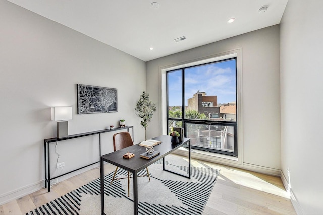 office featuring recessed lighting, light wood-type flooring, baseboards, and visible vents