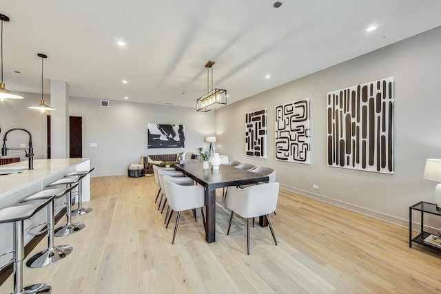 dining area featuring recessed lighting, light wood-type flooring, and baseboards