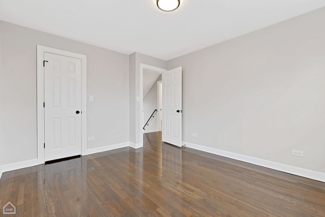 unfurnished bedroom with baseboards and wood finished floors