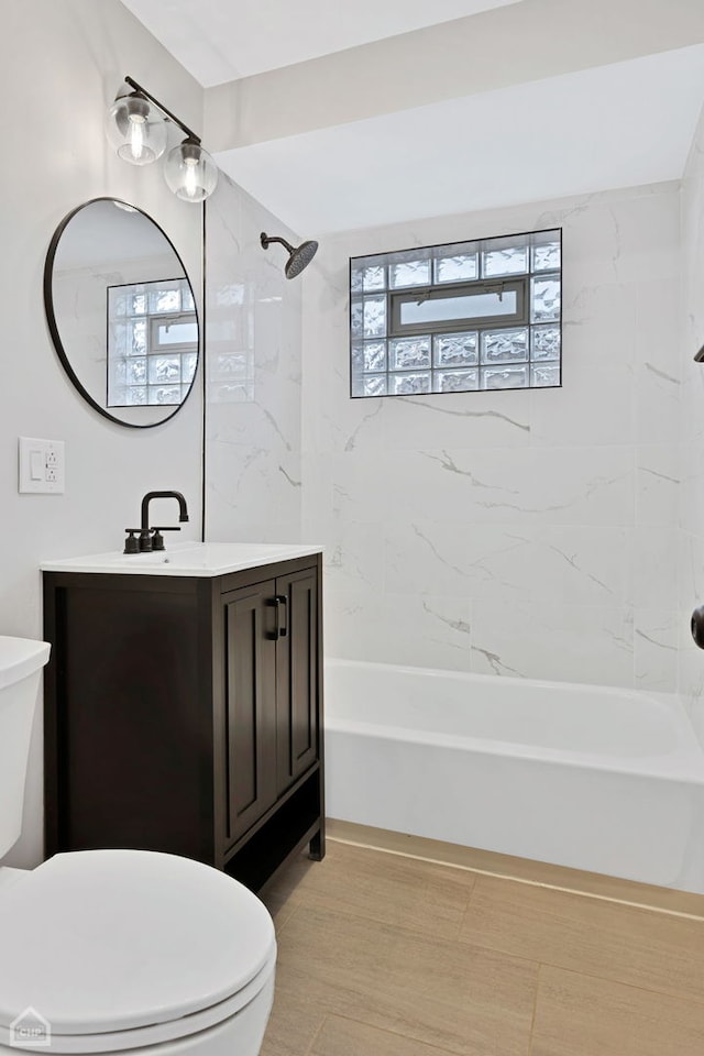 bathroom featuring tub / shower combination, toilet, and vanity