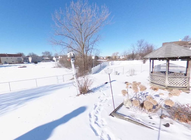 yard layered in snow featuring a gazebo