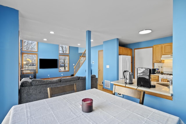 dining space featuring stairs, recessed lighting, and visible vents