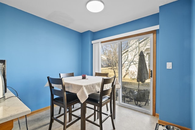 dining area featuring baseboards