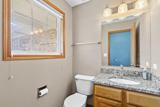 bathroom with toilet and vanity