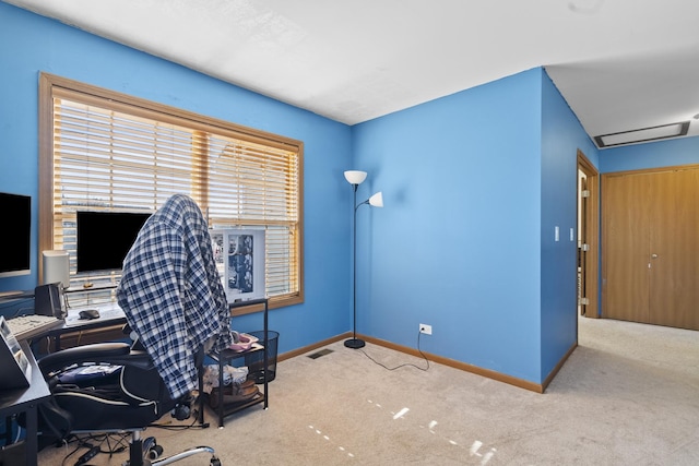 carpeted home office featuring visible vents and baseboards