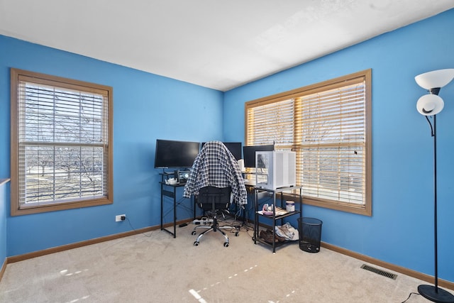 home office with carpet flooring, baseboards, and visible vents