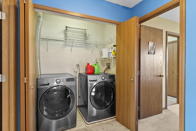 laundry room with laundry area, carpet flooring, and washing machine and dryer