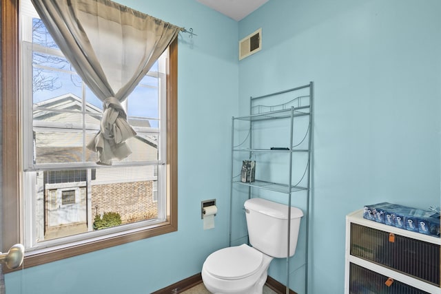 bathroom featuring visible vents, baseboards, and toilet