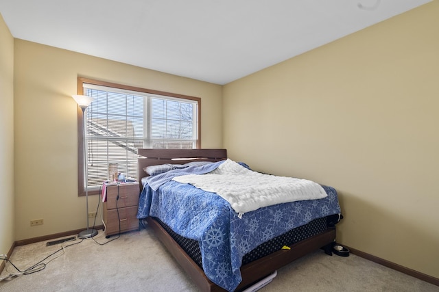 bedroom with visible vents, light carpet, and baseboards