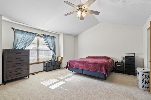 bedroom featuring visible vents, baseboards, carpet floors, lofted ceiling, and ceiling fan