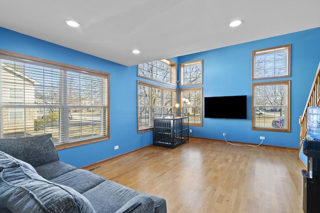 living room with visible vents, recessed lighting, baseboards, and wood finished floors