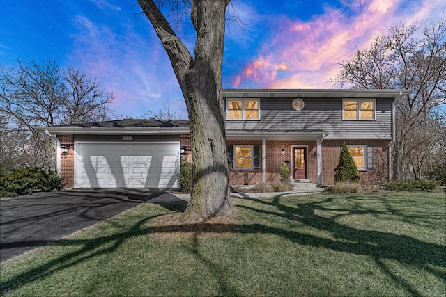 view of front facade featuring aphalt driveway, brick siding, a garage, and a front yard