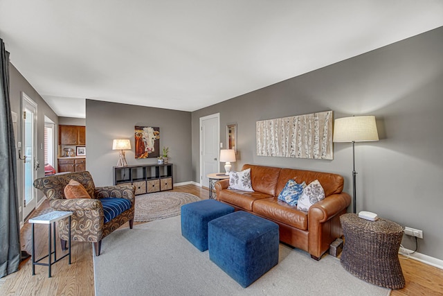 living area featuring light wood finished floors and baseboards