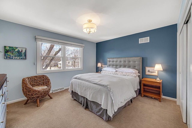 bedroom featuring light colored carpet, visible vents, a closet, and baseboards