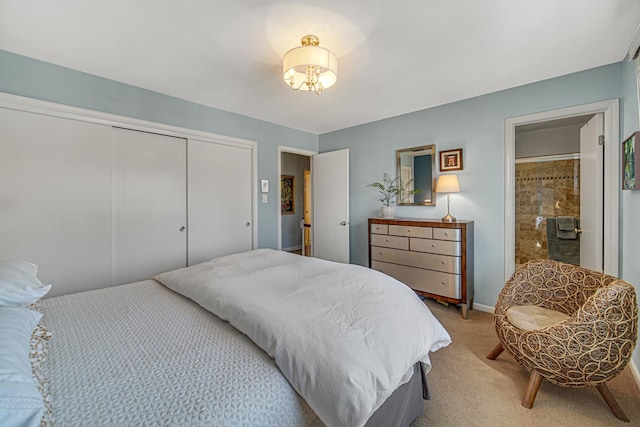 bedroom with light carpet, ensuite bathroom, and a closet