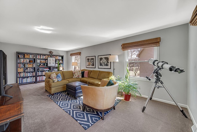 carpeted living area featuring baseboards