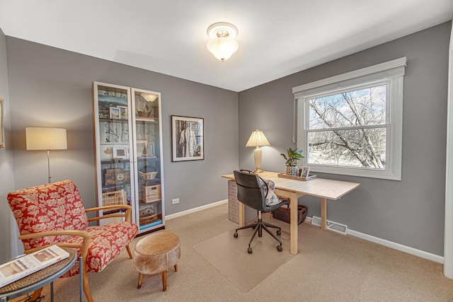 office space with baseboards, visible vents, and carpet floors