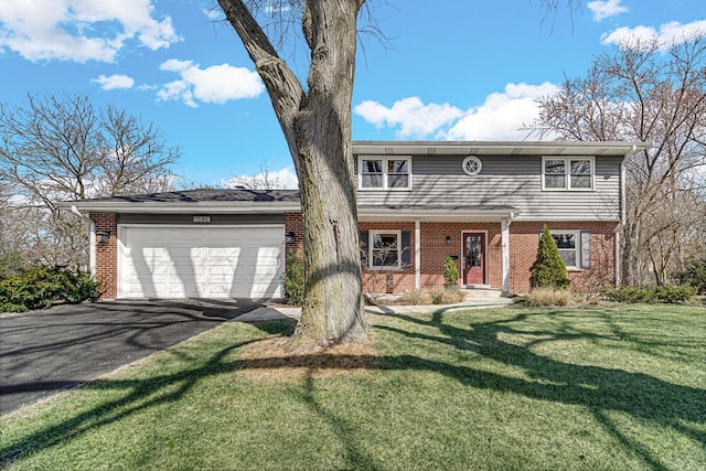 view of front of house with a garage, a front yard, brick siding, and driveway