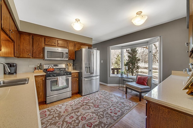 kitchen featuring a sink, light countertops, and stainless steel appliances