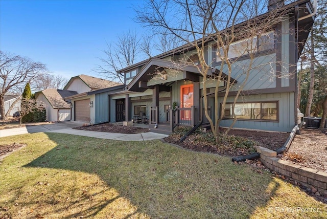 view of front of home with central AC unit, an attached garage, concrete driveway, and a front yard