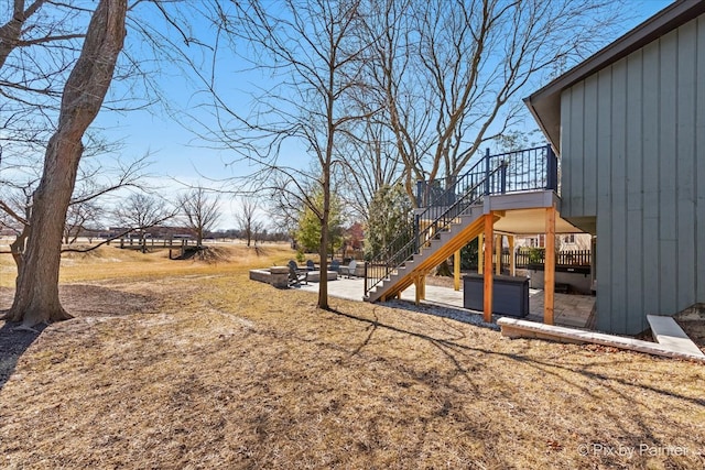 view of yard featuring stairway and a deck