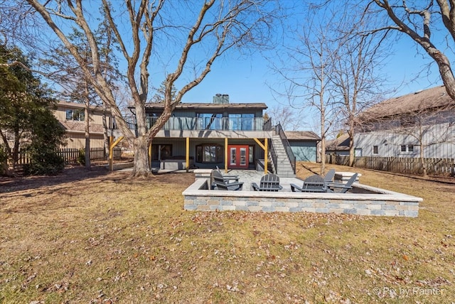 rear view of house featuring a yard, a fenced backyard, french doors, a fire pit, and a patio area