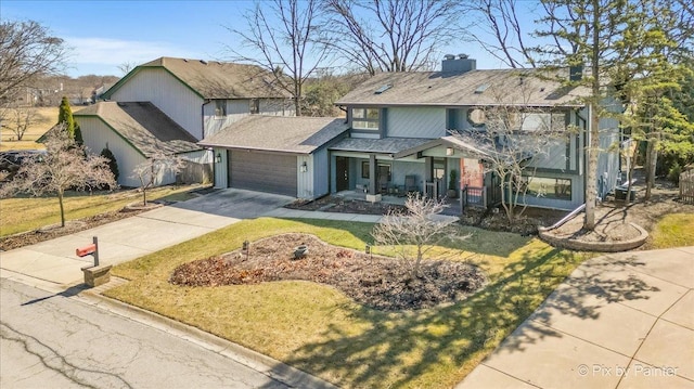 view of front of home featuring a shingled roof, a front yard, a chimney, a garage, and driveway