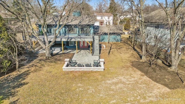 back of house featuring a deck and a yard