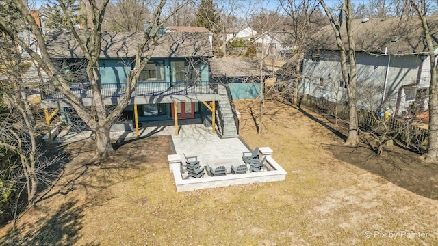 back of property with a patio, a yard, and a wooden deck