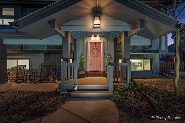 doorway to property with covered porch and board and batten siding