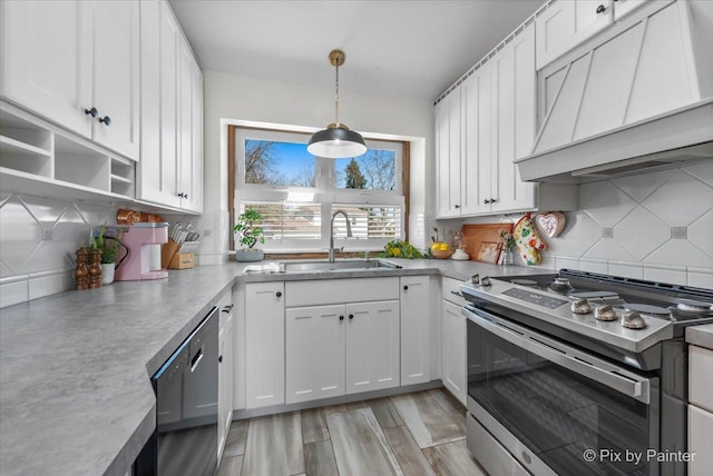 kitchen with black dishwasher, custom exhaust hood, white cabinets, stainless steel range, and a sink