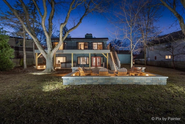 back of house with fence, stairway, french doors, a chimney, and a deck