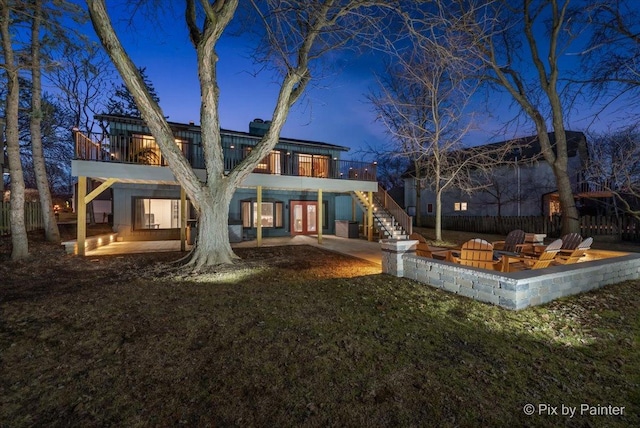 back of property with fence, stairway, a lawn, french doors, and a patio