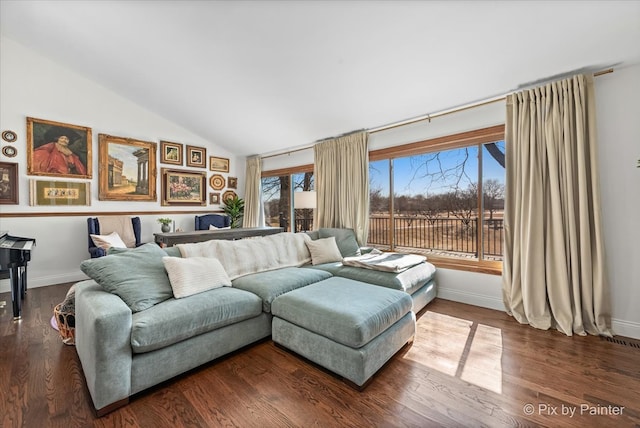 living area with wood finished floors, baseboards, and vaulted ceiling