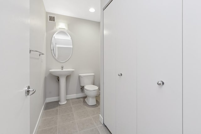 bathroom featuring visible vents, baseboards, toilet, and tile patterned flooring