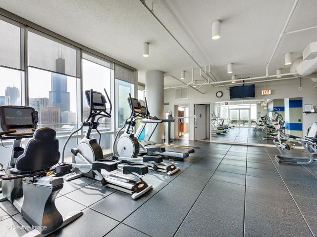 workout area featuring a view of city and a textured ceiling