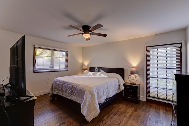 bedroom featuring dark wood finished floors, baseboards, and ceiling fan