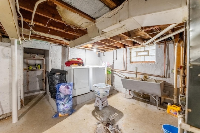 basement with washer and dryer and a sink