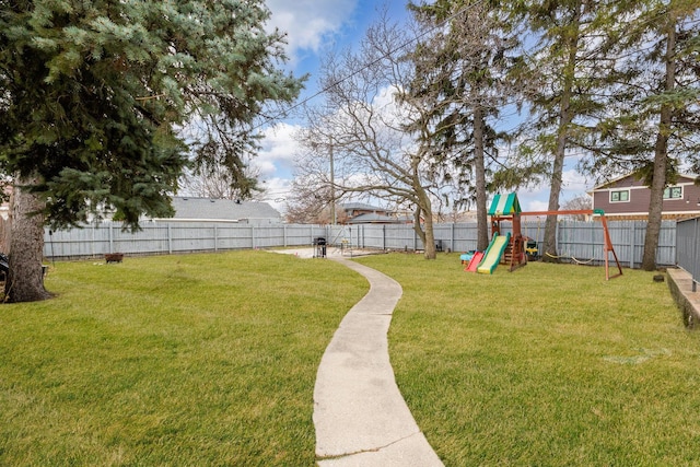 view of yard featuring a playground and a fenced backyard