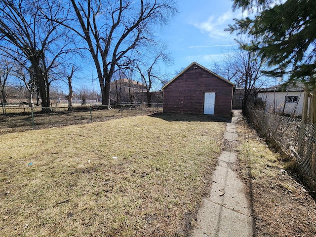 view of yard with an outbuilding and fence