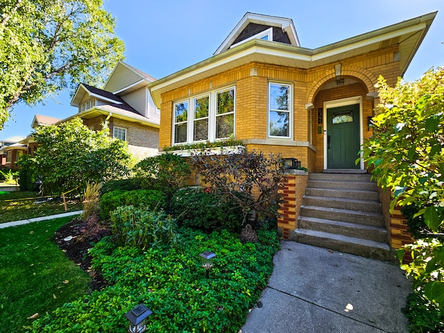 view of exterior entry with brick siding