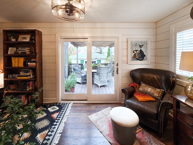 entryway with wooden walls, a healthy amount of sunlight, and wood finished floors